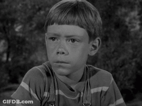 A Black And White Photo Of A Young Boy GIF