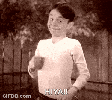 A Black And White Photo Of A Young Boy Saying Hiya ! GIF