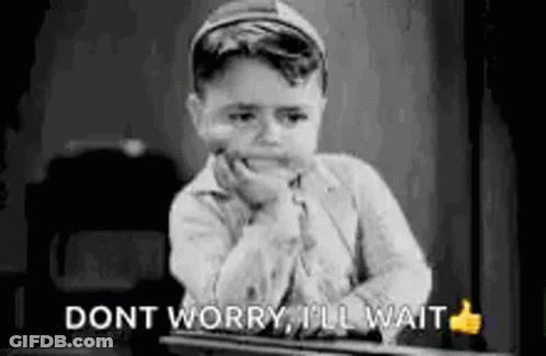 A Black And White Photo Of A Young Boy Sitting At A Desk With His Hand On His Chin And A Thumbs Up . GIF