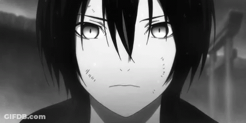 A Black And White Photo Of A Young Boy With Long Black Hair And Big Eyes . GIF