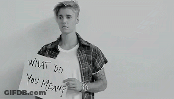 A Black And White Photo Of A Young Man Holding A Sign That Says `` What Do You Mean '' . GIF