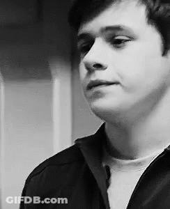 A Black And White Photo Of A Young Man In A Black Jacket . GIF