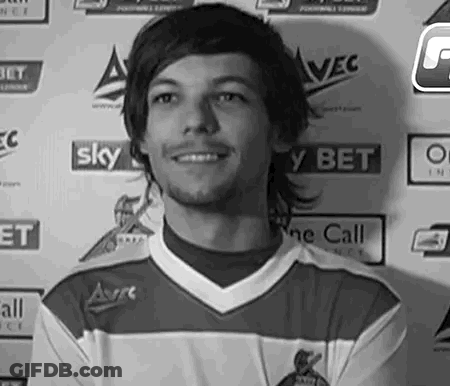 A Black And White Photo Of A Young Man In A Soccer Jersey Smiling . GIF