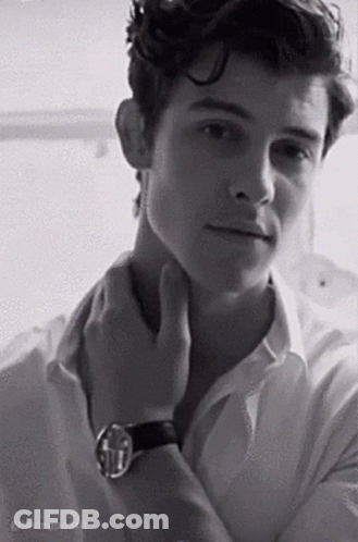 A Black And White Photo Of A Young Man In A White Shirt And A Watch . GIF