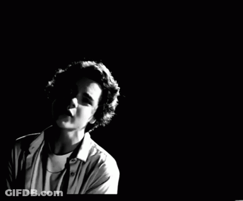 A Black And White Photo Of A Young Man GIF