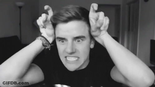 A Black And White Photo Of A Young Man Making A Face GIF