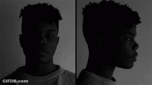 A Black And White Photo Of A Young Man GIF