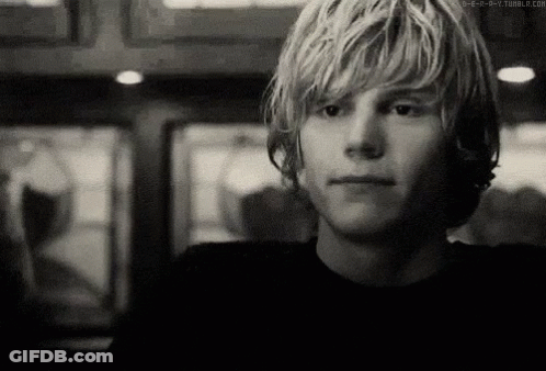 A Black And White Photo Of A Young Man 'S Face GIF