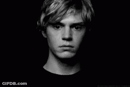 A Black And White Photo Of A Young Man 'S Face With A Serious Look On His Face . GIF