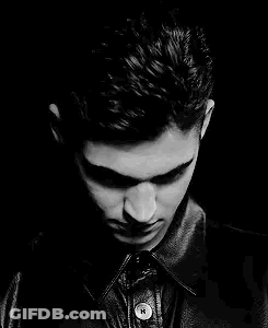 A Black And White Photo Of A Young Man Wearing A Leather Jacket And Looking At The Camera . GIF