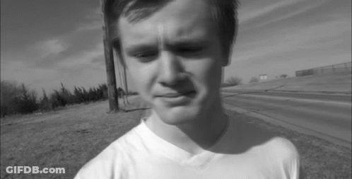 A Black And White Photo Of A Young Man Wearing A White T-Shirt GIF