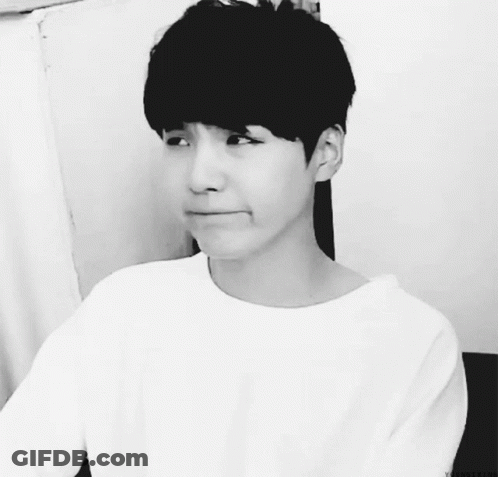 A Black And White Photo Of A Young Man With A White Shirt On GIF