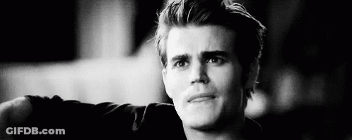 A Black And White Photo Of A Young Man With His Arm Outstretched . GIF