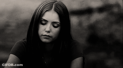 A Black And White Photo Of A Young Woman With Her Eyes Closed . GIF