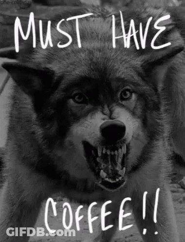 A Black And White Photo Of An Angry Wolf With The Words Must Have Coffee Written On It GIF