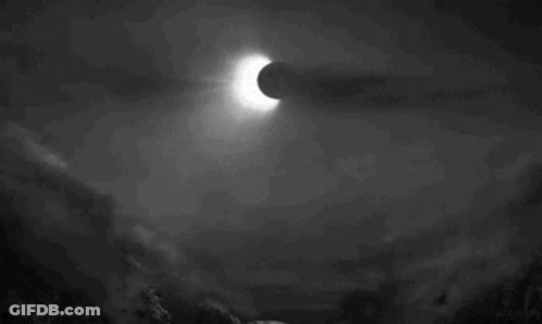 A Black And White Photo Of An Eclipse In The Night Sky GIF