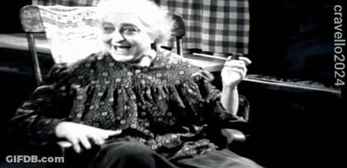 A Black And White Photo Of An Elderly Woman Sitting In A Rocking Chair With The Year 2024 On The Bottom GIF