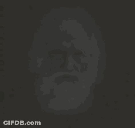 A Black And White Photo Of An Older Man With A Long Beard GIF