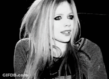 A Black And White Photo Of Avril Lavigne Wearing A Hoodie . GIF