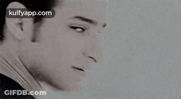 A Black And White Photo Of Elvis Presley 'S Face With A White Background . GIF