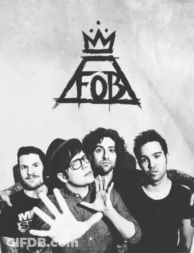 A Black And White Photo Of Four Men With A Fob Logo Behind Them GIF