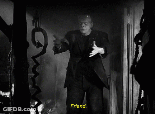 A Black And White Photo Of Frankenstein Holding A Snake With The Words Friend Below Him GIF