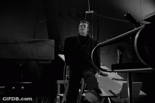 A Black And White Photo Of Frankenstein In A Dark Room GIF
