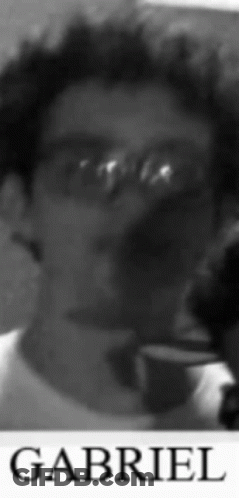 A Black And White Photo Of Gabriel With Glasses On GIF