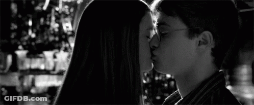 A Black And White Photo Of Harry Potter Andginny Weasley Kissing . GIF