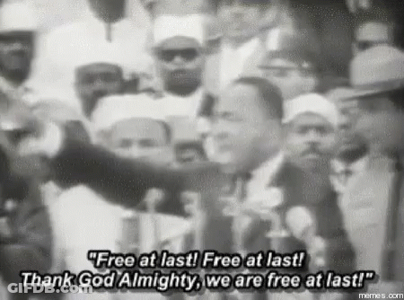A Black And White Photo Of Martin Luther King Jr. Speaking In Front Of A Crowd . GIF