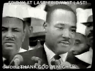 A Black And White Photo Of Martin Luther King Jr. Speaking Into A Microphone In Front Of A Crowd Of People . GIF