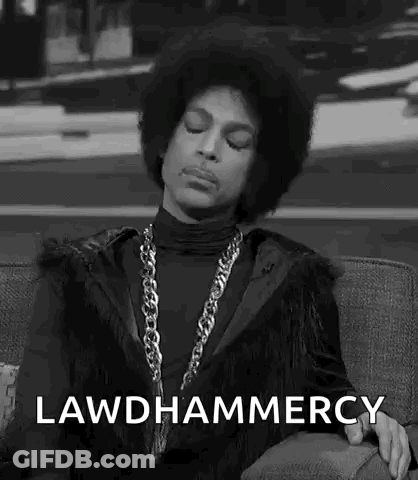 A Black And White Photo Of Prince Sitting On A Couch With His Eyes Closed And A Chain Around His Neck . GIF