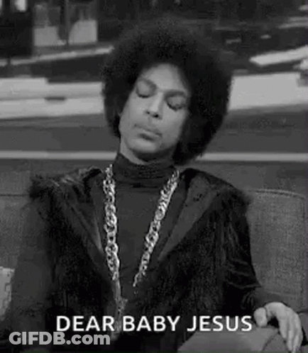 A Black And White Photo Of Prince Sitting On A Couch With His Eyes Closed And A Chain Around His Neck . GIF