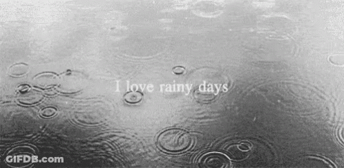 A Black And White Photo Of Rain Drops On A Body Of Water With The Words `` I Love Rainy Days '' GIF