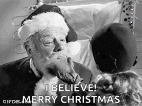 A Black And White Photo Of Santa Claus Kissing A Little Girl And Saying `` I Believe Merry Christmas '' . GIF