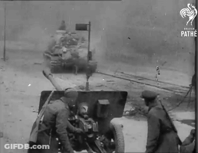 A Black And White Photo Of Soldiers And A Tank Taken By The Pathe GIF