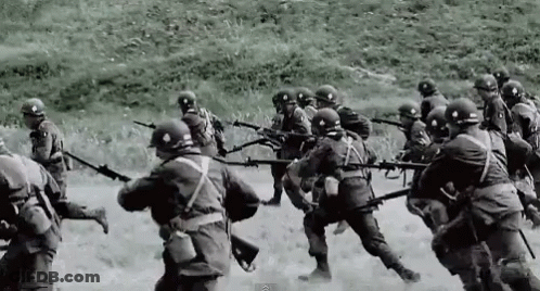 A Black And White Photo Of Soldiers Holding Guns GIF