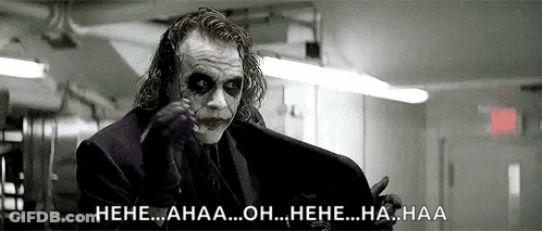 A Black And White Photo Of The Joker From The Movie The Dark Knight Rises Laughing . GIF