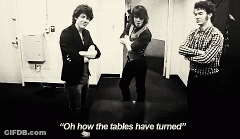 A Black And White Photo Of Three Men Standing Next To Each Other With One Saying " Oh How The Tables Have Turned " GIF