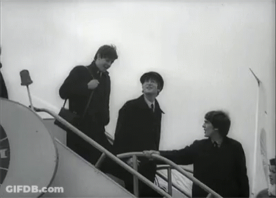 A Black And White Photo Of Three Men Walking Up Stairs . GIF