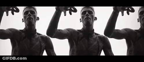 A Black And White Photo Of Three Men With Tattoos On Their Bodies . GIF