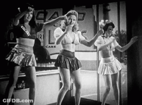 A Black And White Photo Of Three Women Dancing In Front Of A Store . GIF