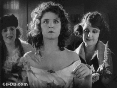 A Black And White Photo Of Three Women In A Room . GIF