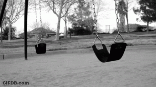 A Black And White Photo Of Two Empty Swings GIF