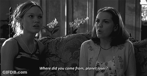 A Black And White Photo Of Two Girls Sitting On A Couch With One Saying " Where Did You Come From Planet Loser " GIF