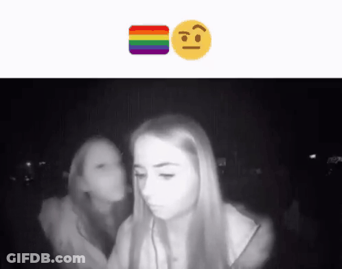 A Black And White Photo Of Two Girls With A Rainbow Smiley Face GIF