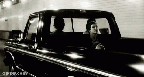 A Black And White Photo Of Two Men In A Truck Taken By Dailydoogie GIF