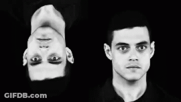 A Black And White Photo Of Two Men 'S Faces One Is Upside Down GIF