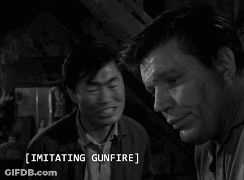 A Black And White Photo Of Two Men With The Caption Imitating Gunfire On The Bottom GIF