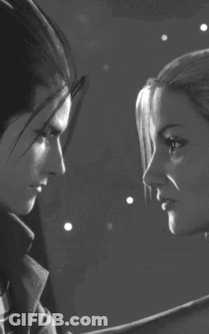 A Black And White Photo Of Two People Kissing GIF